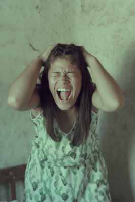 screaming woman holding her head