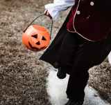 child holding halloween candy basket