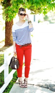 A woman wearing a striped shirt, sunglasses, and red pants. Image from Wikimedia Commons.